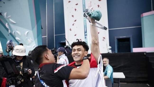 Foto: Hendra Basir memeluk Veddriq Leonardo usai raih medali emas Olimpiade 2024. (REUTERS/Benoit Tessier)