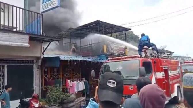 Foto: Pemadam berusaha memadamkan api di rumah yang terbakar di Jalan Malik Ibrahim, Kisaran.