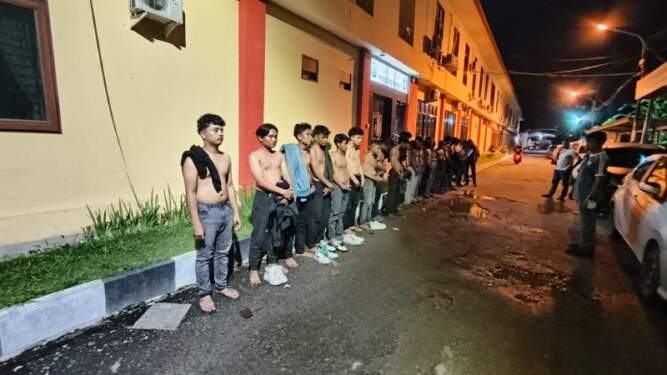 Foto: Sebanyak 21 orang anggota geng motor saat diamankan di halaman Sat Reskrim Polresta Deli Serdang.