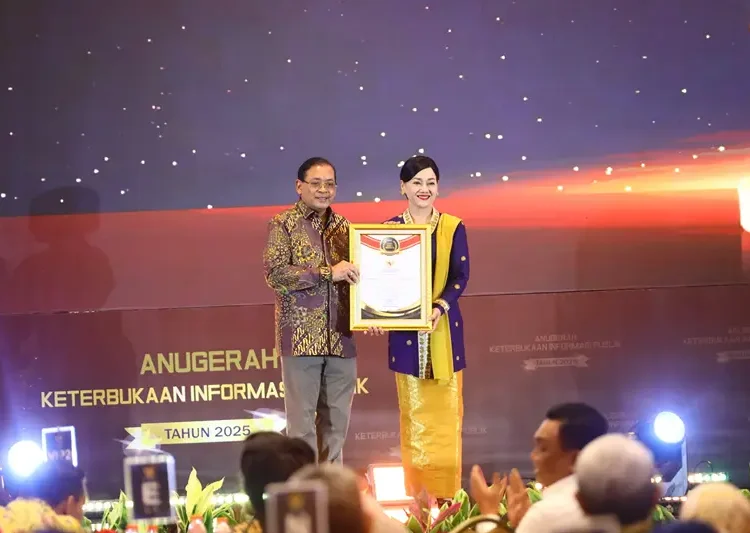 Ketua Komisi Informasi Pusat (KIP) Donny Yoesgiantoro menyerahkan penghargaan kepada Kepala Eksekutif Pengawas Perilaku Pelaku Usaha Jasa Keuangan, Edukasi dan Pelindungan Konsumen OJK Friderica Widyasari Dewi, Senin (15/12) di Jakarta.(Dok:OJK)